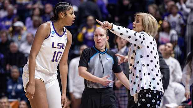 Tigers head coach Kim Mulkey gives directions to forward Angel Reese while playing Michigan.